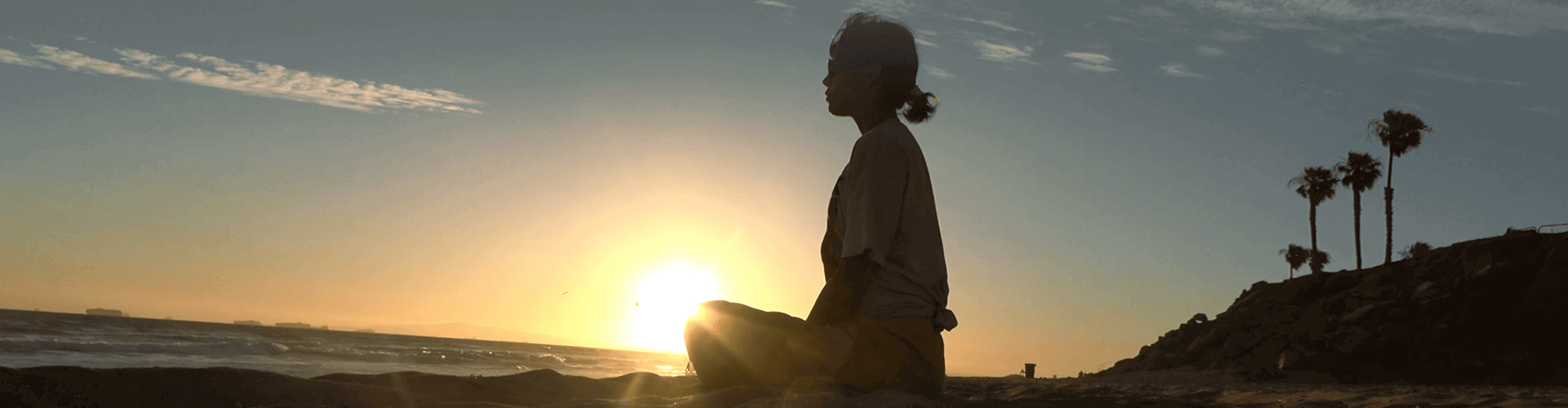 a woman on the sunset beach