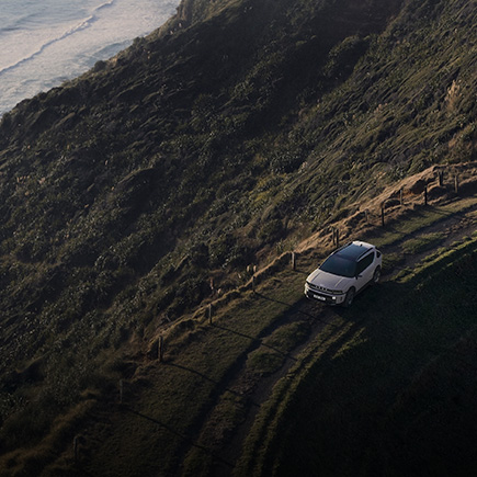 Hyundai NEXO driving along a coastal cliff road