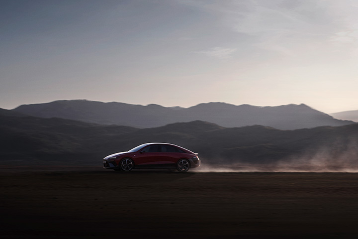 Side profile view of driving IONIQ 6