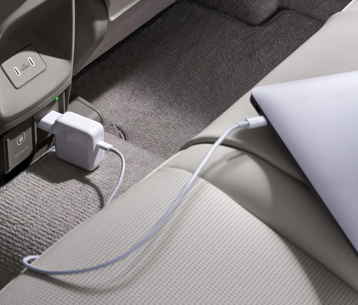 A laptop charging through the indoor V2L port inside the all-new NEXO.