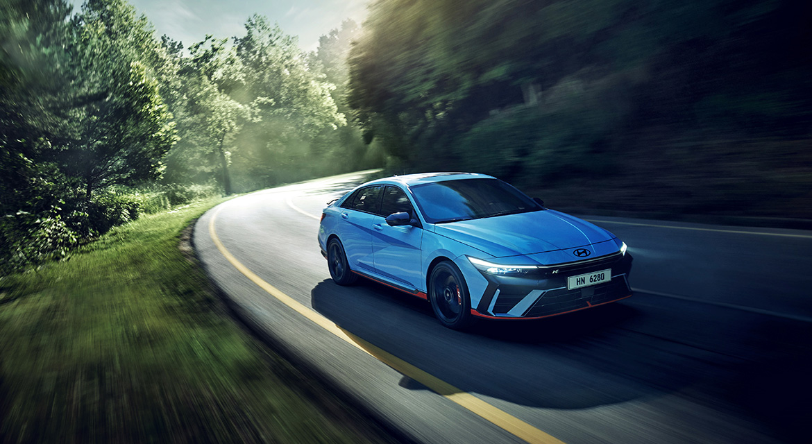 New ELANTRA N, driving on a winding road, three-quarter front view