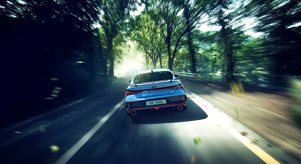 New ELANTRA N, driving on a winding road, rear view