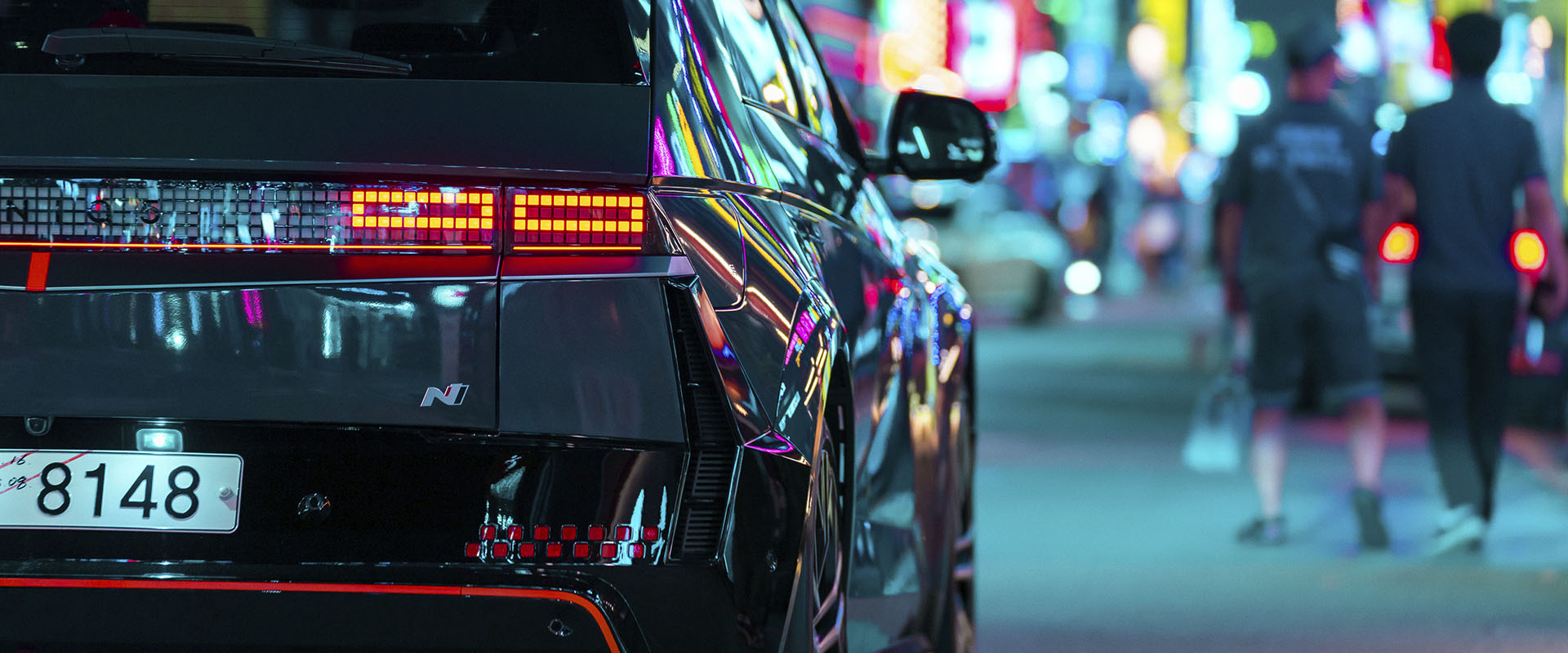 Seoul's Gangnam streets come alive at night, bathed in a neon glow and buzzing with atmosphere