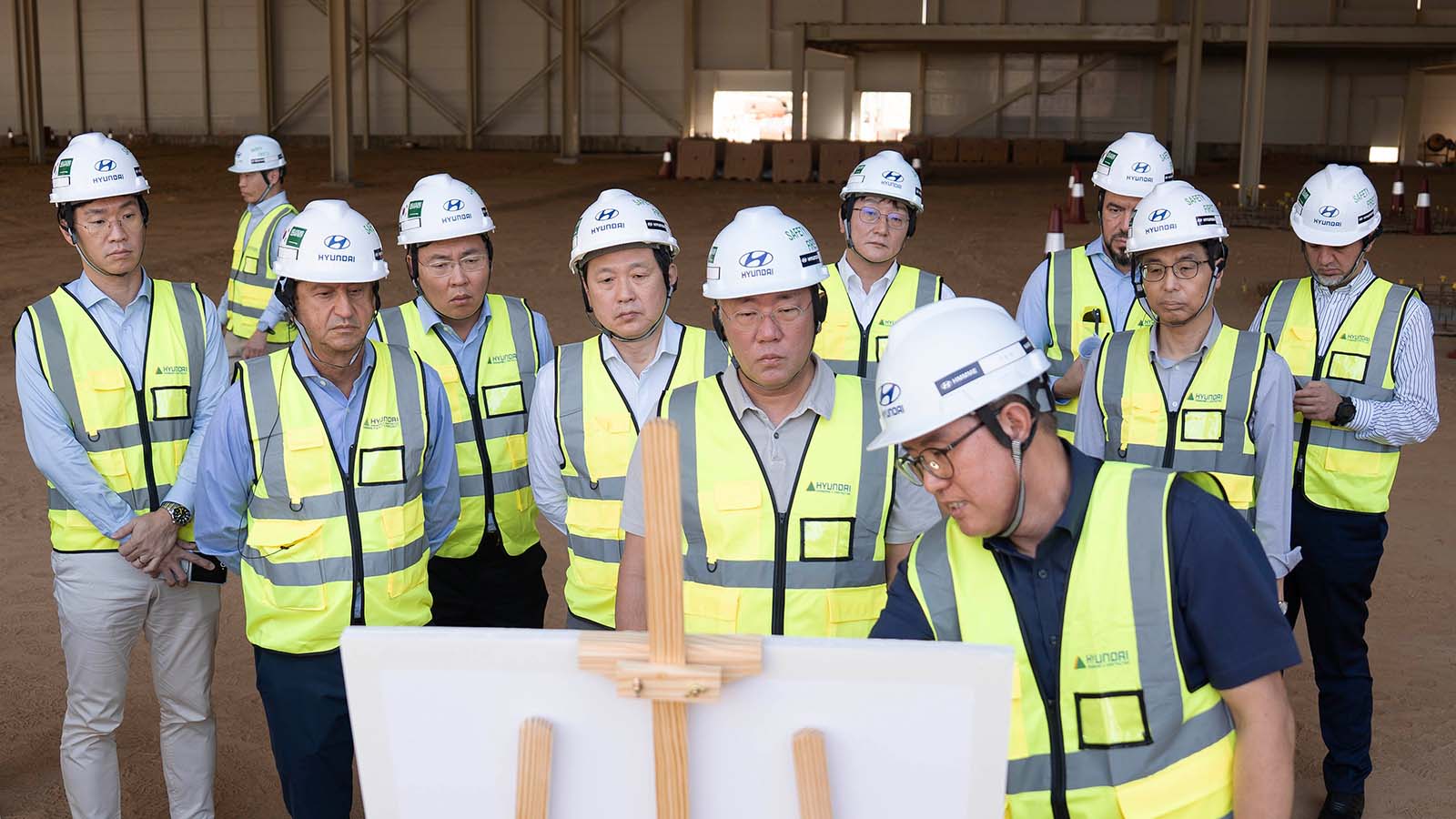 Executive Chair Euisun Chung and José Muñoz, President and CEO of Hyundai Motor Company, are briefed by HMMME Head Wonkyn Park on the progress of the new plant in Saudi Arabia