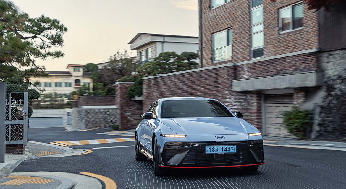 The Ioniq 6 N, finished in Performance Blue Pearl, cuts a distinctive figure as it cruises through the peaceful streets of Seongbuk-gu at dawn.
