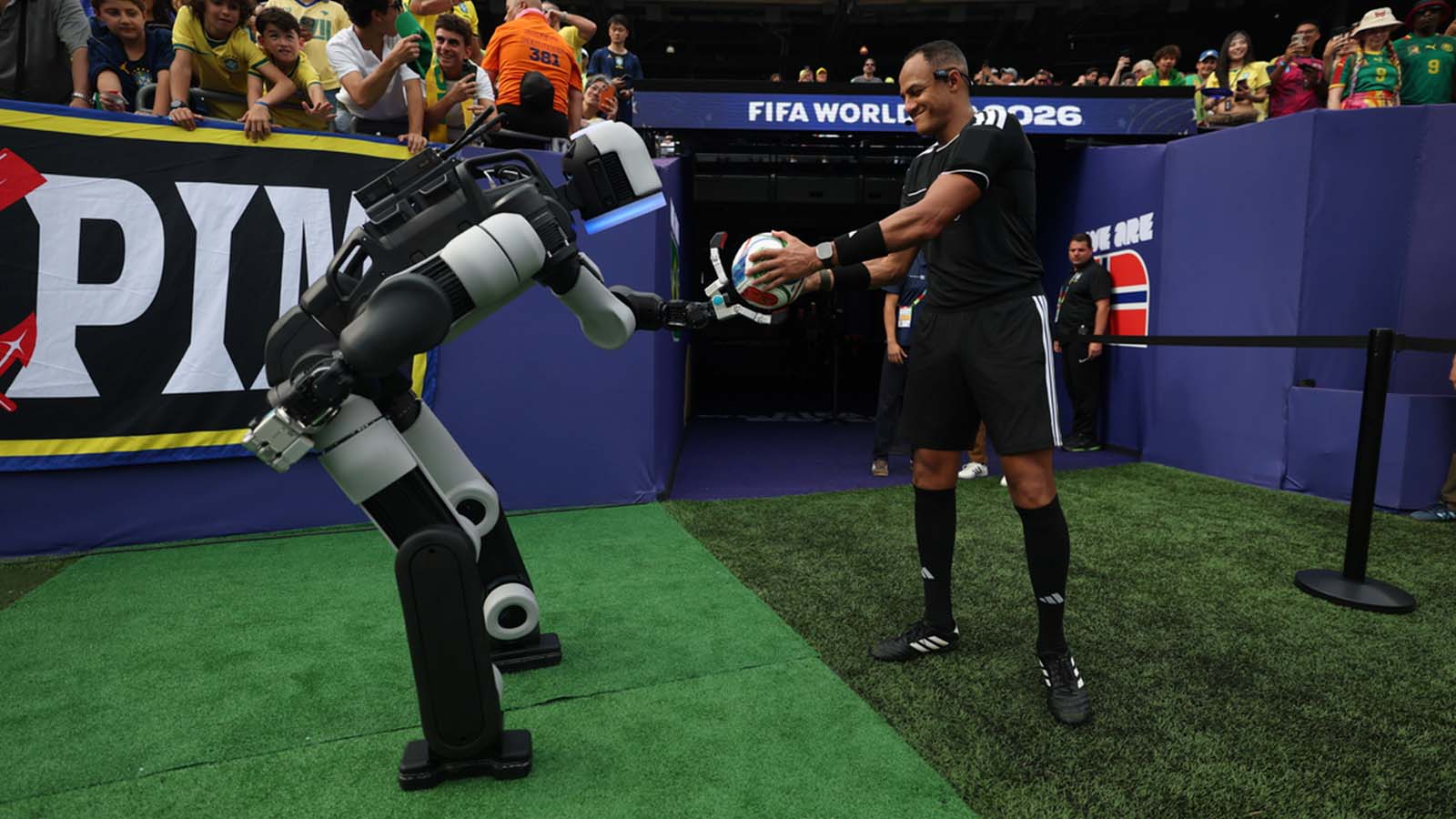 Atlas® delivers the ceremonial match ball to the referee during halftime of a Round of 16 match at New York/New Jersey Stadium at the FIFA World Cup 2026™.