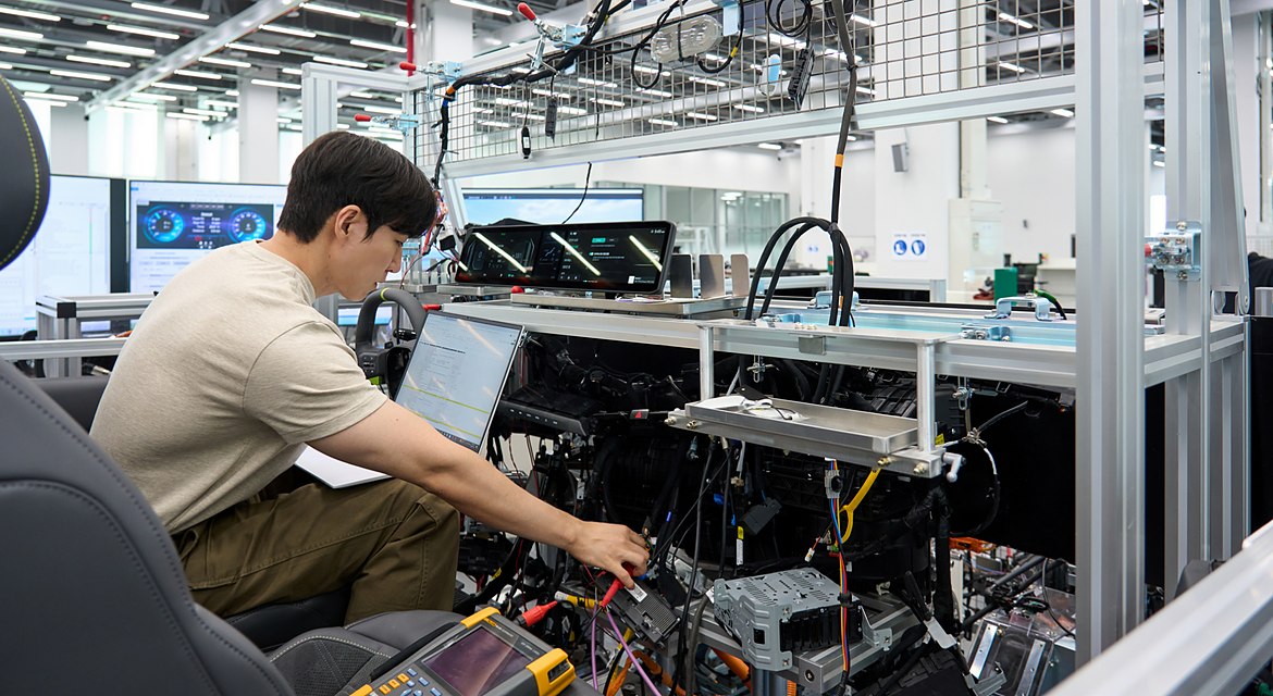 Engineer validates vehicle functions and electronic control systems using a full-scale wire-car test bench at NOVA Lab.