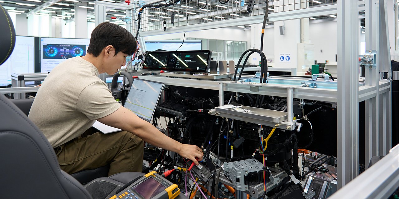 Engineer validates vehicle functions and electronic control systems using a full-scale wire-car test bench at NOVA Lab.