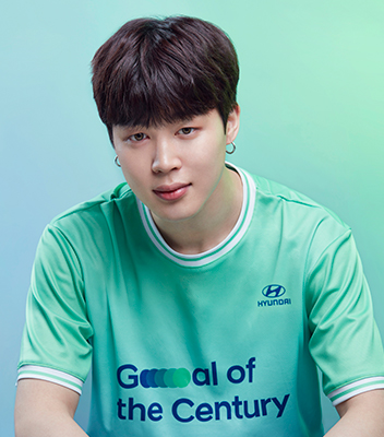 BTS member Jimin wearing a green Team Century shirt.