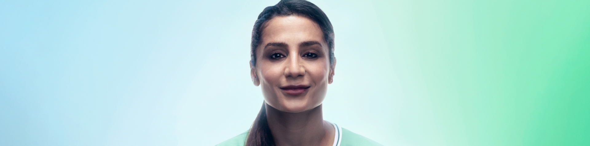 A portrait of Danish football player and Team Century member Nadia Nadim in front of a blue and green background.